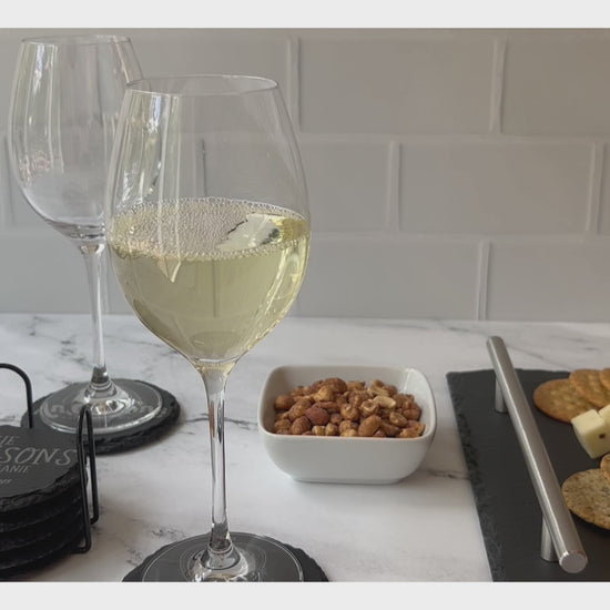 Video Pouring white wine showing personalized round coasters with snacks